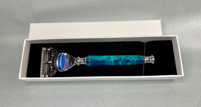 A blue  diamond dust acrylic handle  and nickel plated MAC III razor inside a white card box