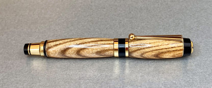 One hand turned hand crafted pen made from Black Ash Wood, It has Gold Plated fittings.