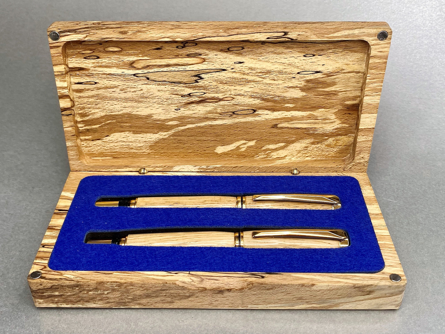 ~Spalted Beech wood hand crafted presentation box with its lid open showing two hand crafted and turned pens made from French Oak and has Gold Plated fittings