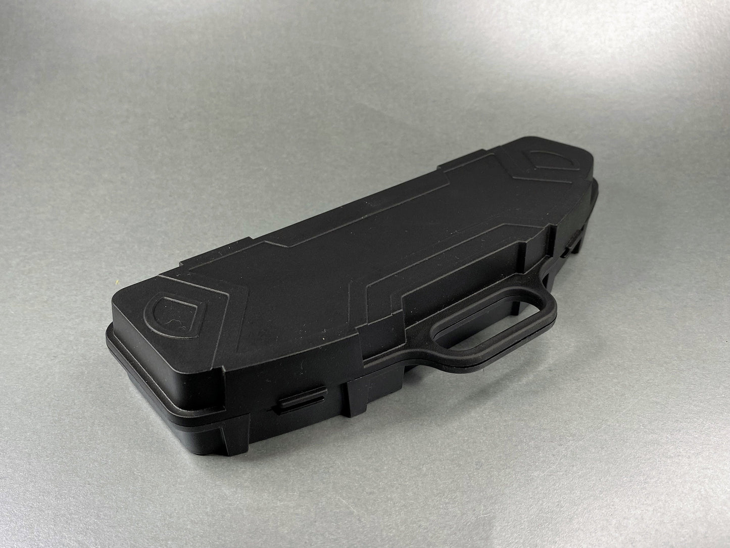 this is the pen sized plastic rifle case in its closed position showing the outside shape simulating the real rifle case but much smaller