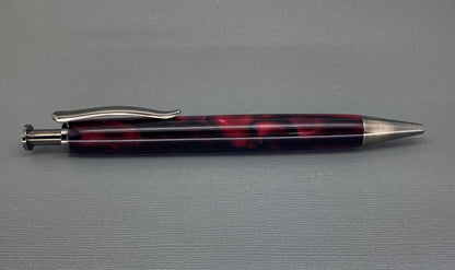 A handturned Red and Black acrylic pen with Chrome plating and the clicker at the pen top to operate the nib.