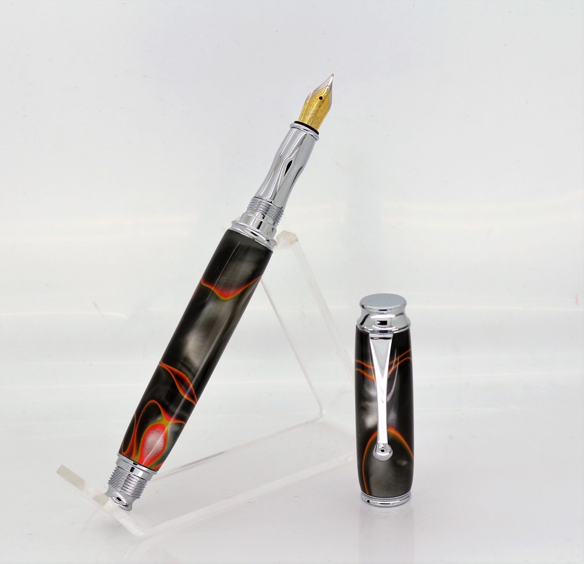 Acrylic Fountain pen  standing on an acrylic clear stand, the pen has chrome plated fittings
