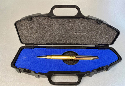 Open pen sized plastic rifle case showing a hand made pen sitting inside its laser cut royal blue insert holding the pen securely. the pen has been made from recycled 308 once fired shells.